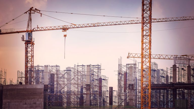 Two cranes with constructions in the background