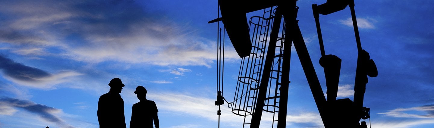 Oil workers at dusk