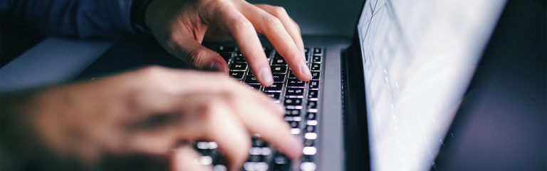 Hands placed on a keyboard