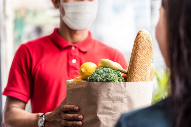 Man in a face mask delivering groceries
