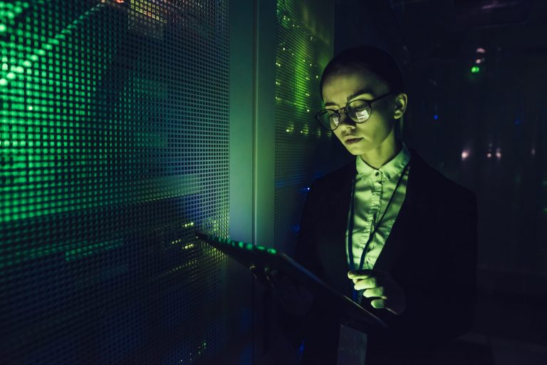 Woman working in data centre with tablet