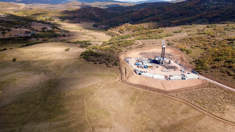 Aerial view of z fracking drilling rig in the autumn mountains of colorado