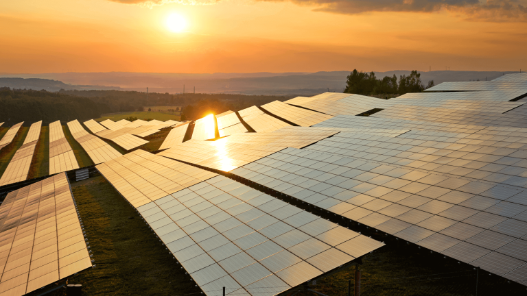 Solar panel farm at sunset