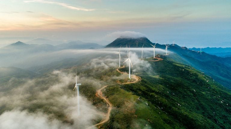 Windmills that produce electricity on top of a mountain range