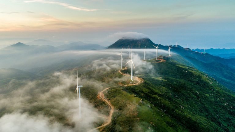 Windmills that produce electricity on top of a mountain range