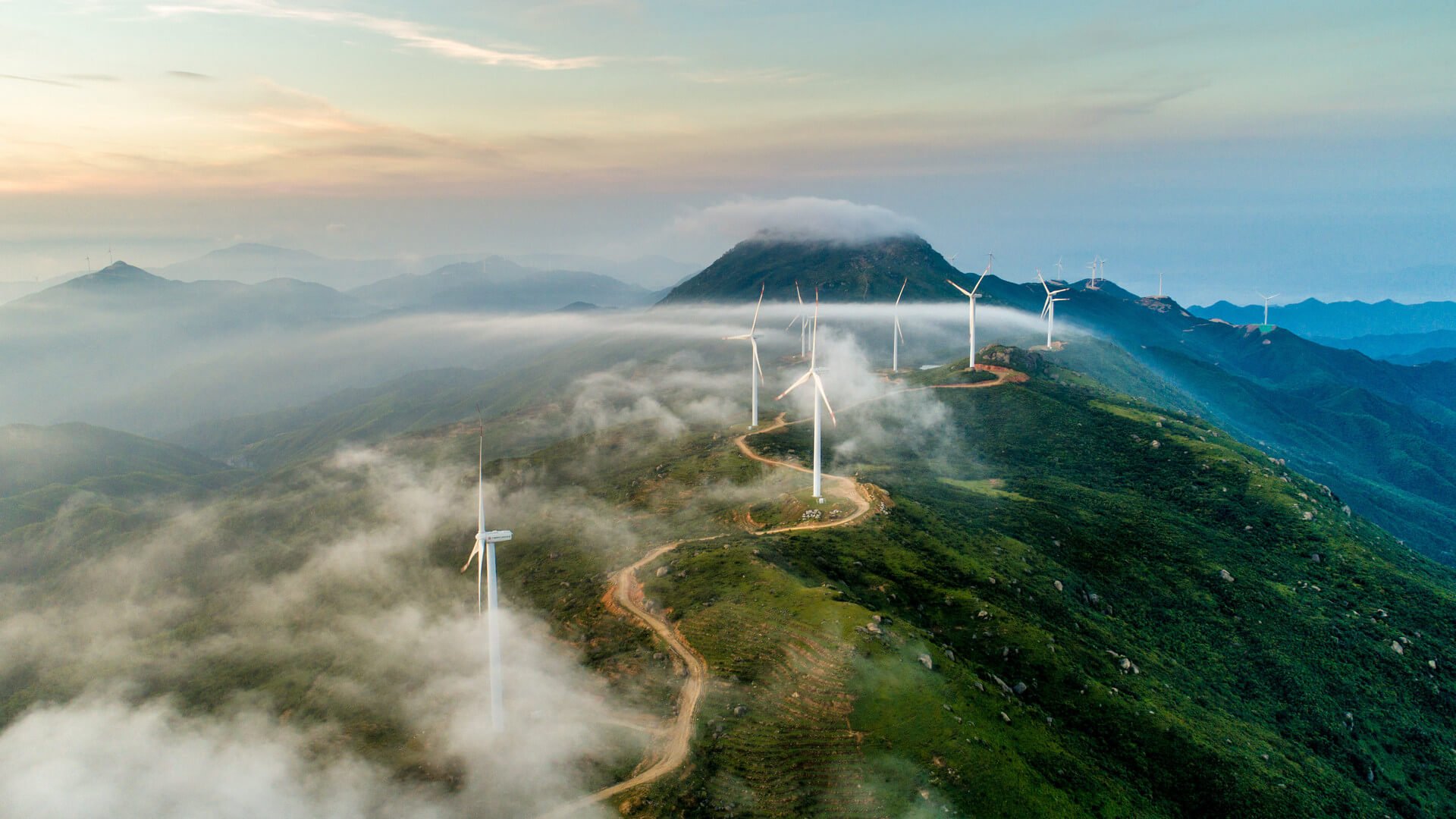 Windmills that produce electricity on top of a mountain range