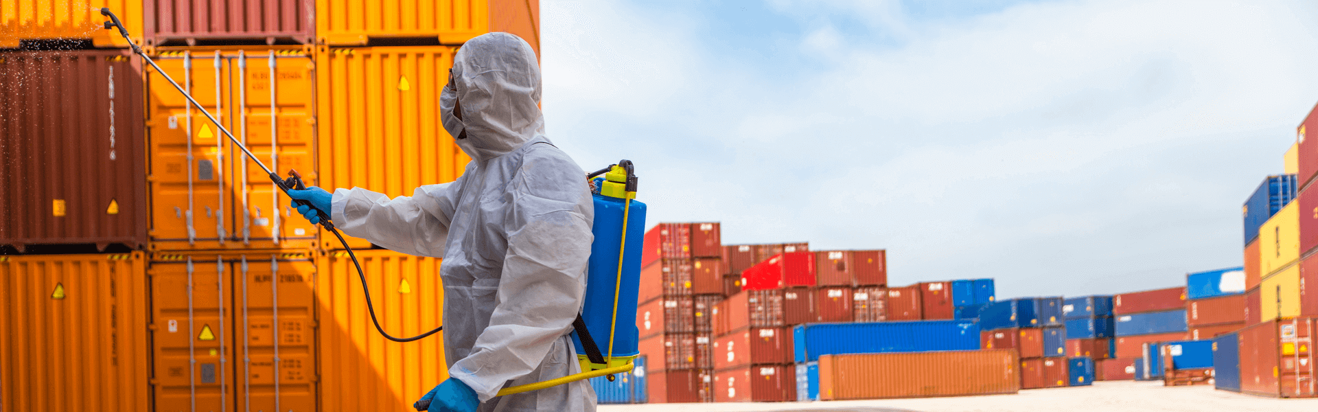 Man cleaning containers with chemicals