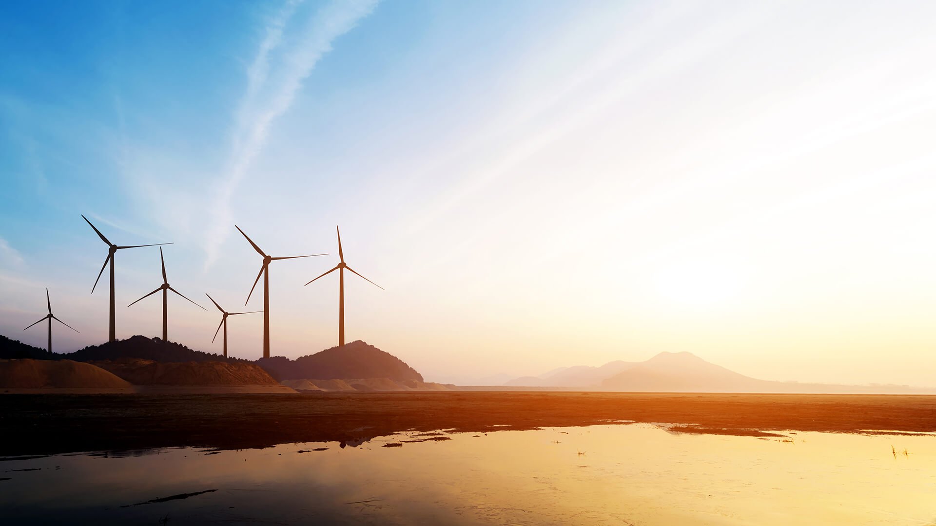 Windmills producing electricity against the backdrop of the mountains