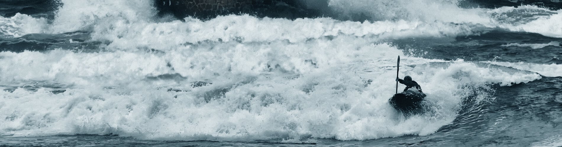 Canoeist sailing on the sea during a storm