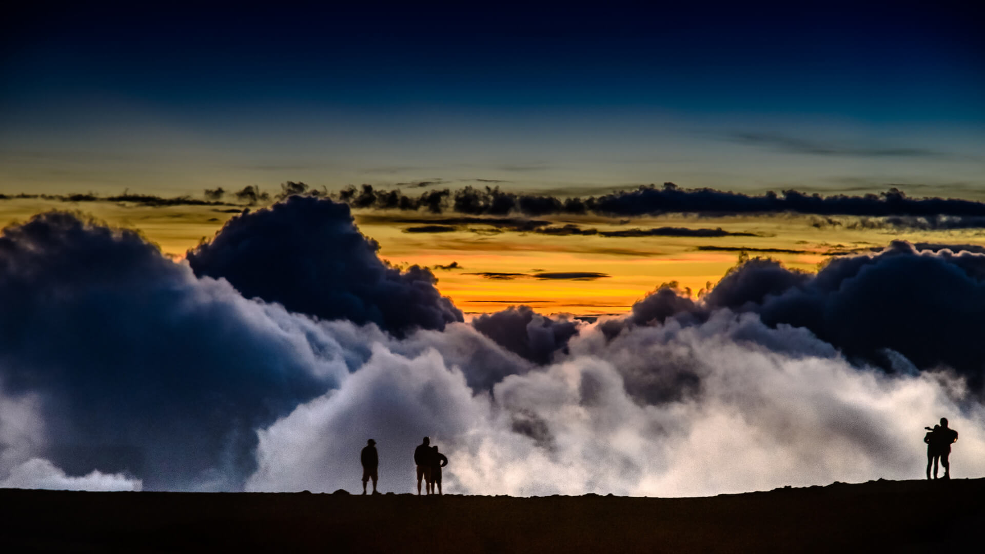 People on a background of clouds at sunrise