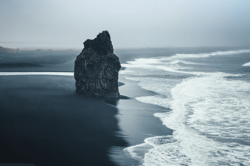 Stone on the seashore under a cloudy sky