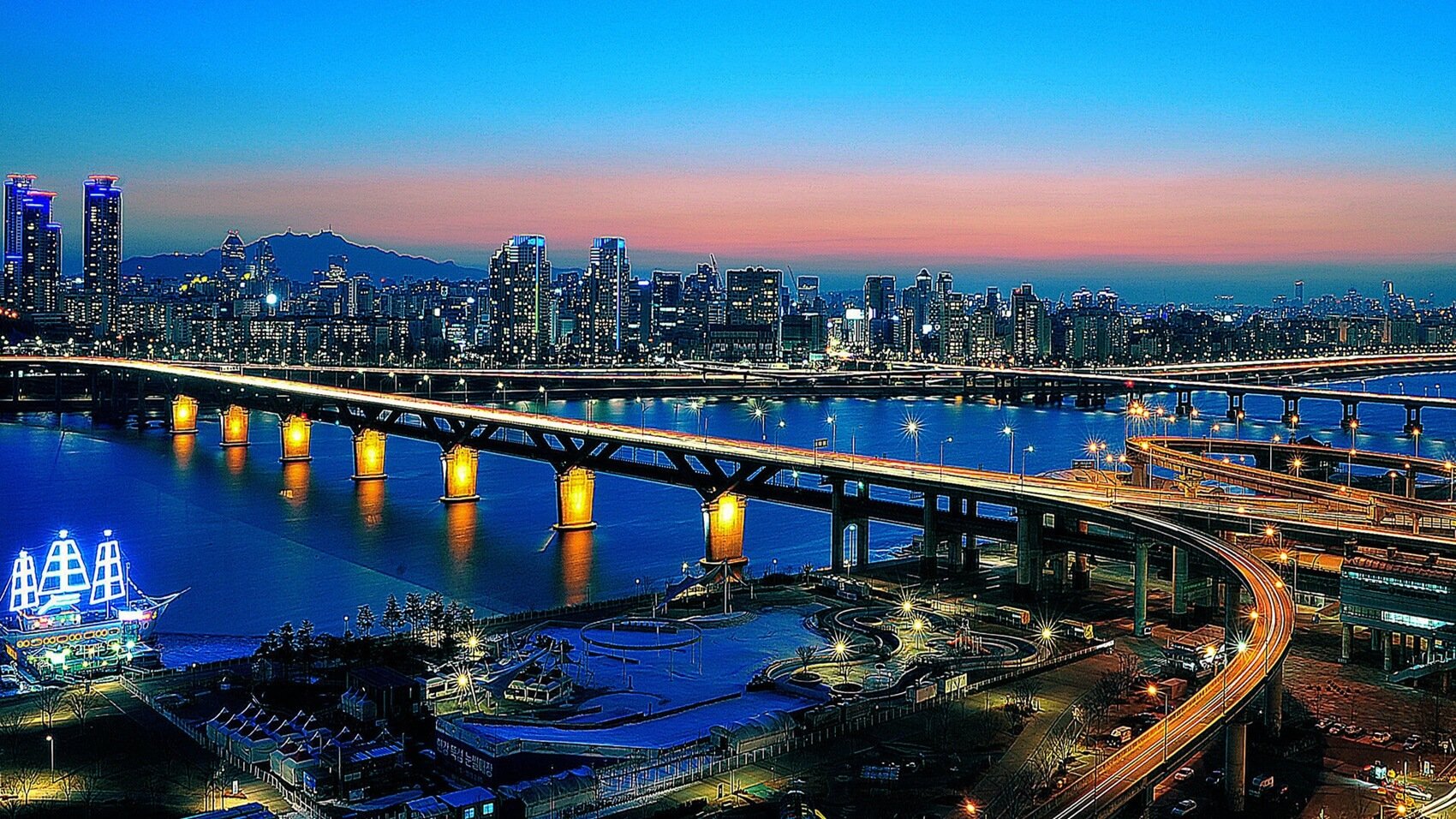 Illuminated bridges connecting two parts of a city divided by a river