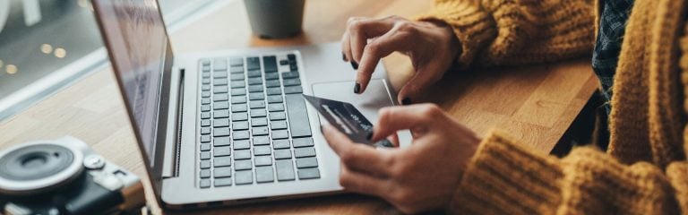 A woman writing data from a card to a laptop