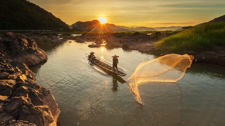 Men taking a boat at sunset