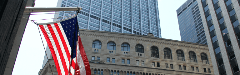 American flag on the background of skyscrapers