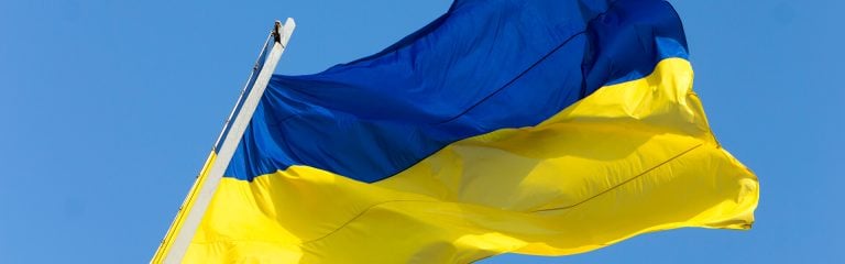 Ukrainian national flag against the blue sky close up