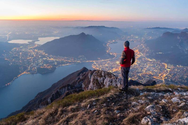 Men looking down on a lighted city