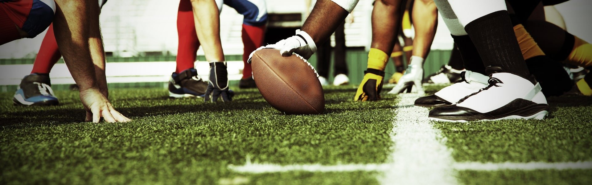 Rugby ball and team members legs