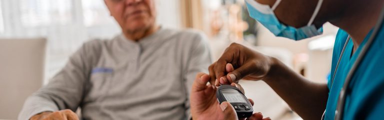 Specialist checks patient's blood sugar level