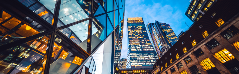 Looking directly up at the skyline of the financial district in central London