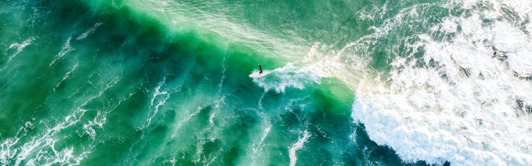 birds eye viw of a surfer riding a big wave