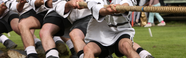 a team of people lead a tug of war on a rope