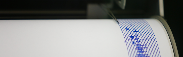 Seismograph pen scribbles an earthquake