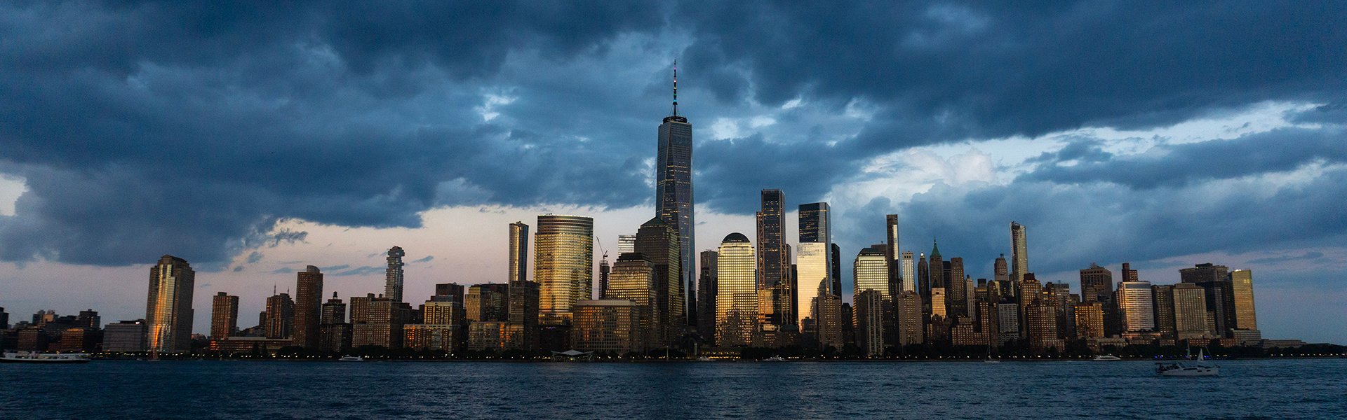 Manhattan waterfront under a stormy sky.