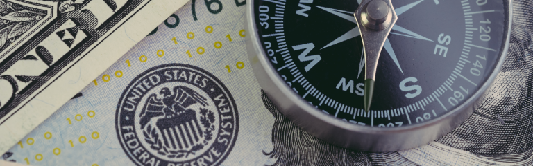 Compass on US dollar banknote with Federal Reserve emblem