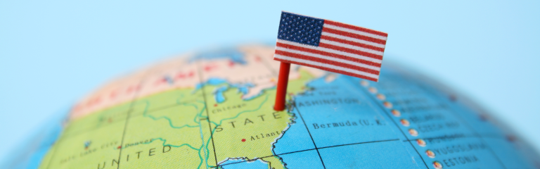 small, felt US flag, pinned into a toy globe