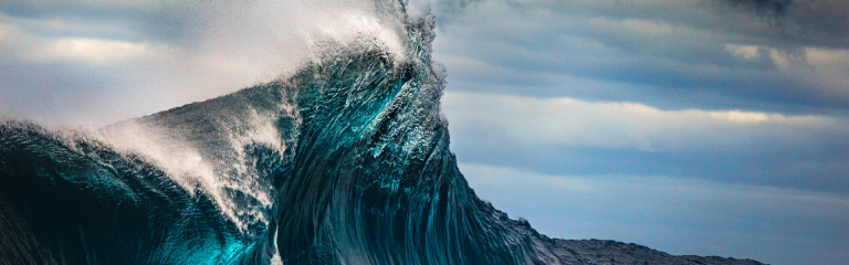 close-up shot of the peak of a wave crashing