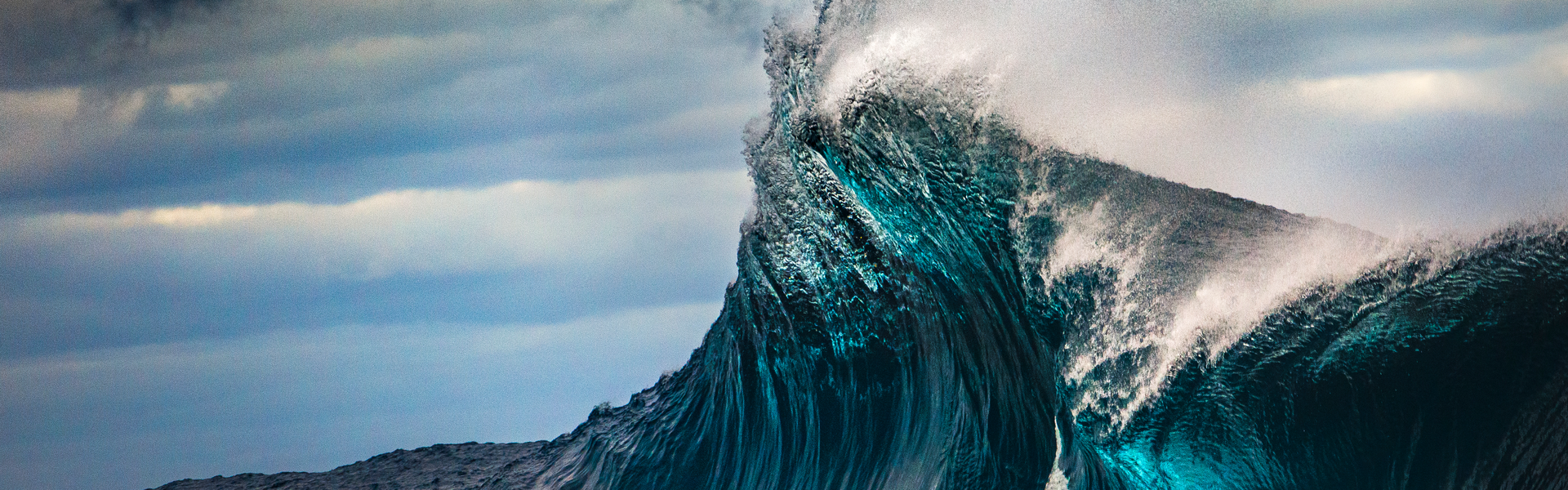 close-up shot of the peak of a wave crashing