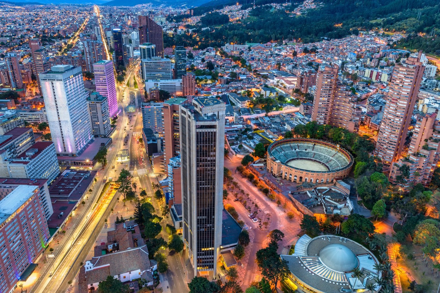 A birds-eye view of Bogota at night, encompassing a number of skyscrapers and other buildings.