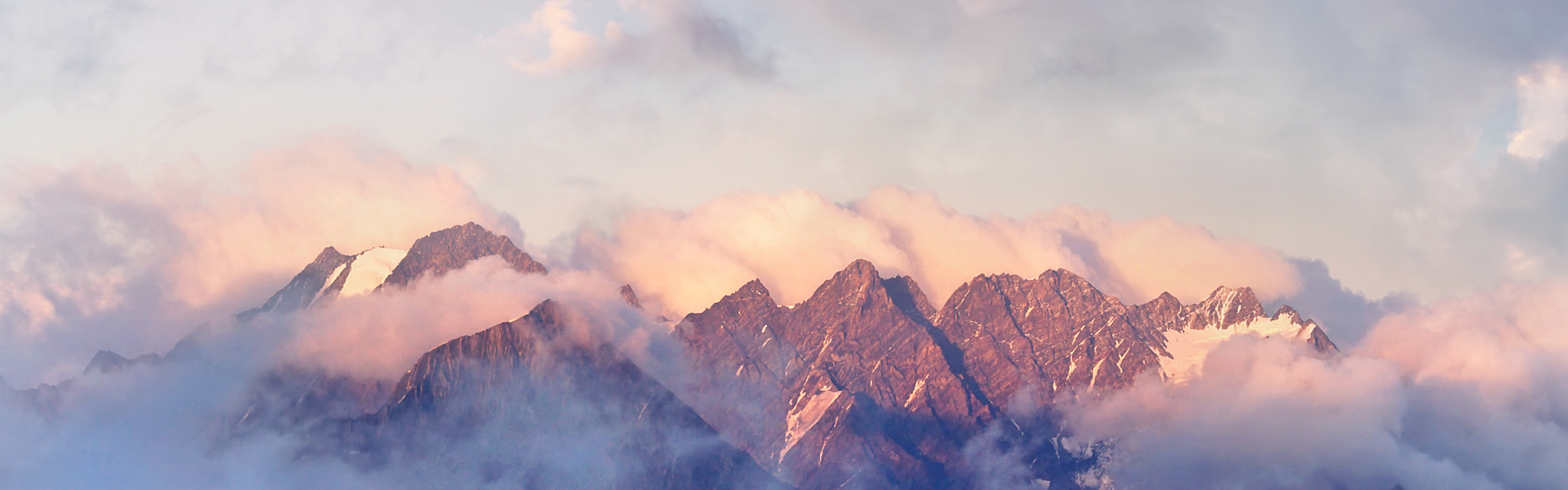 Snowy mountain peaks with low cloud