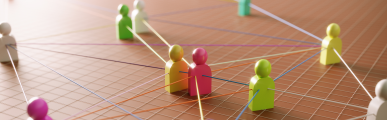 various colourful wooden figurines, tied together with string