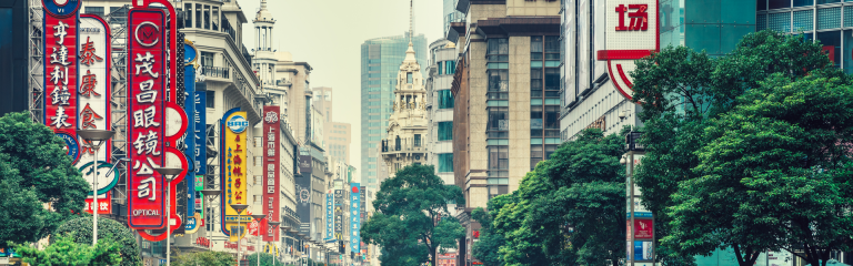 Busy street in Shanghai with store signs