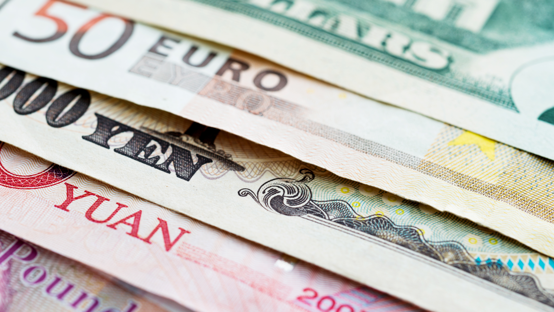 a series of overlapping bank notes of different currencies