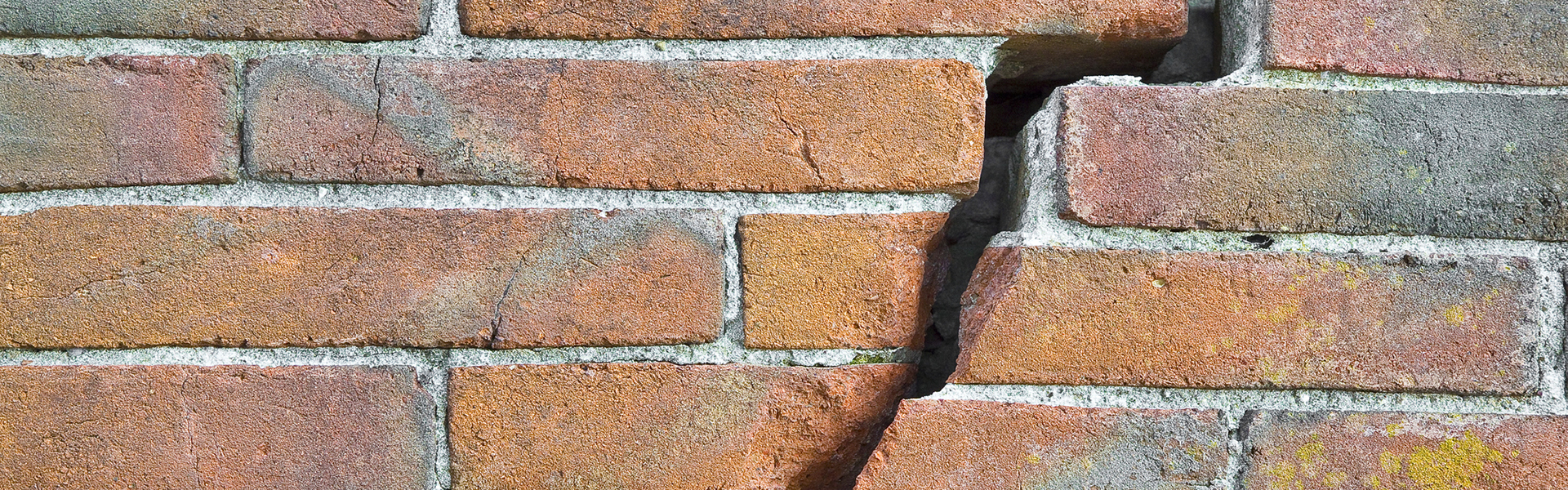 a brick wall with a crack in it