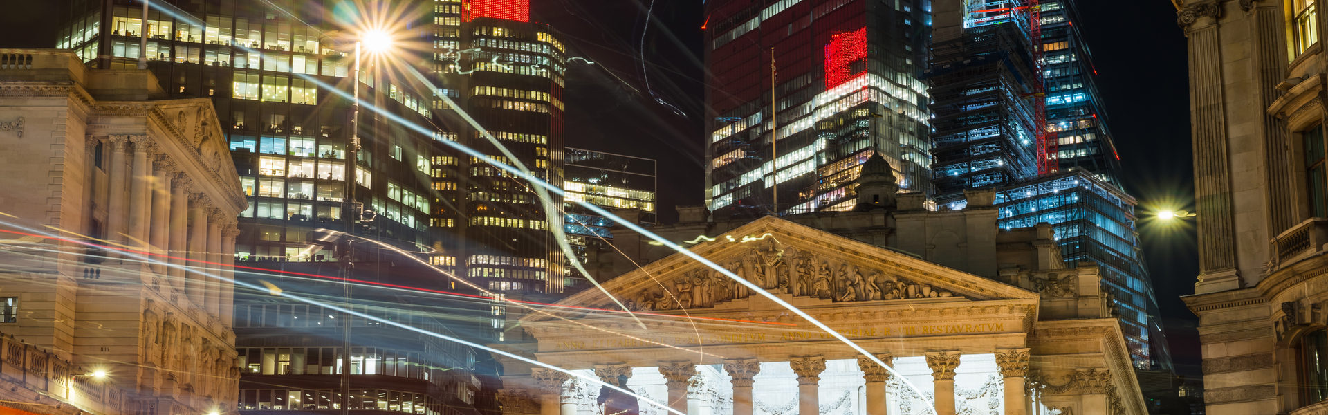 Bank of England and Cirt of London at night with lights banner image