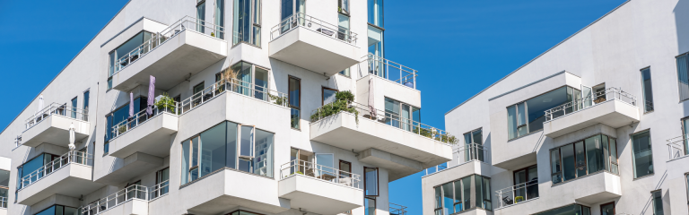 Modern white multifamily residential building in Copenhagen, Denmark