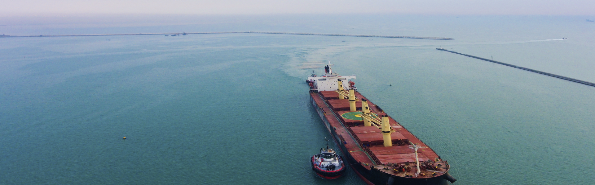 Image of a cargo ship travelling across a calm ocean