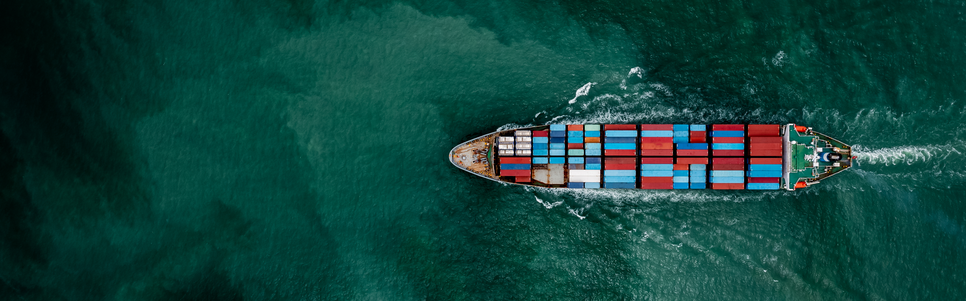 Aerial view looking down ship and sea banner image