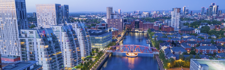 Aerial shot of Salford Quays in Manchester at dusk overlooking canal banner image
